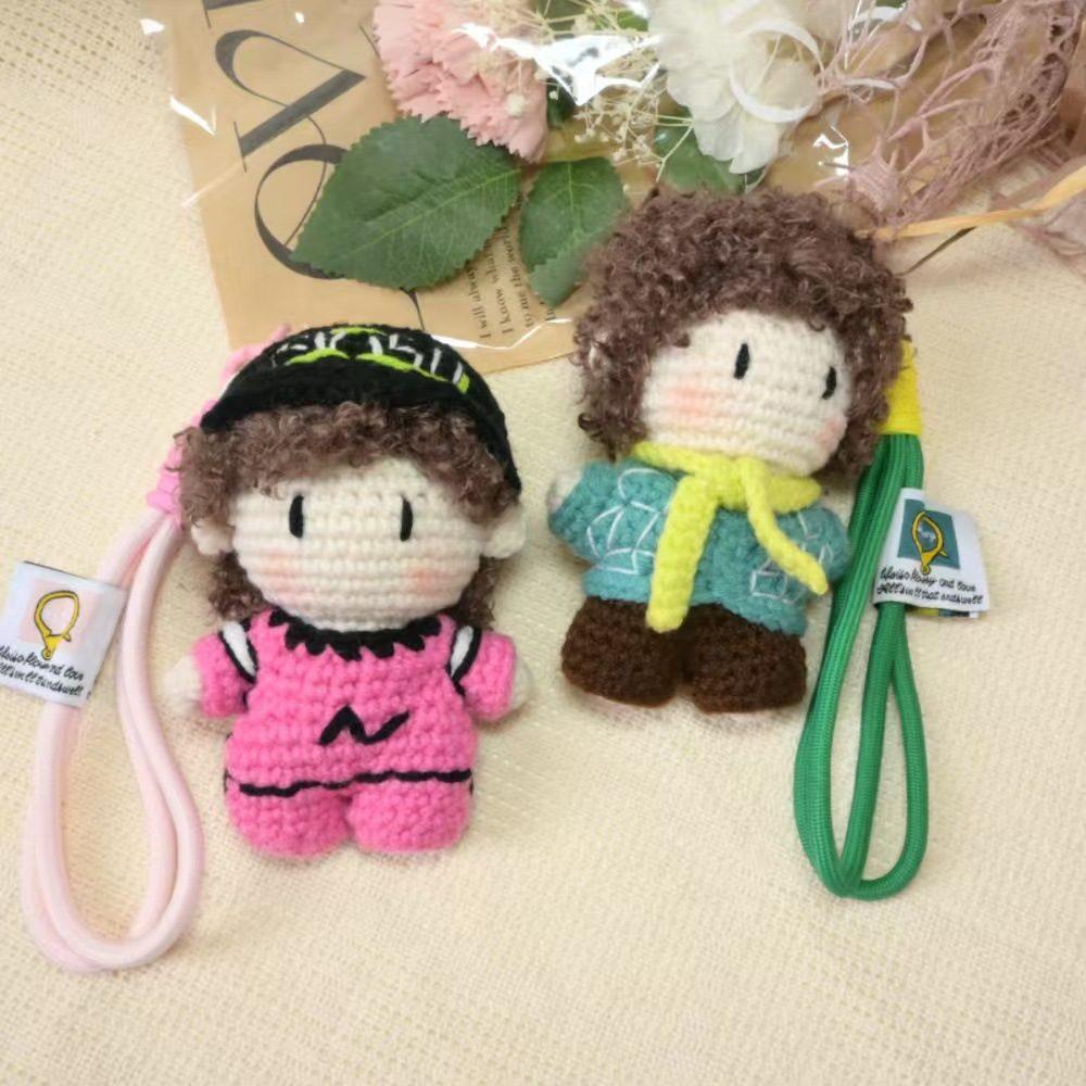 Pair of handmade crochet character keychains with pink and green straps