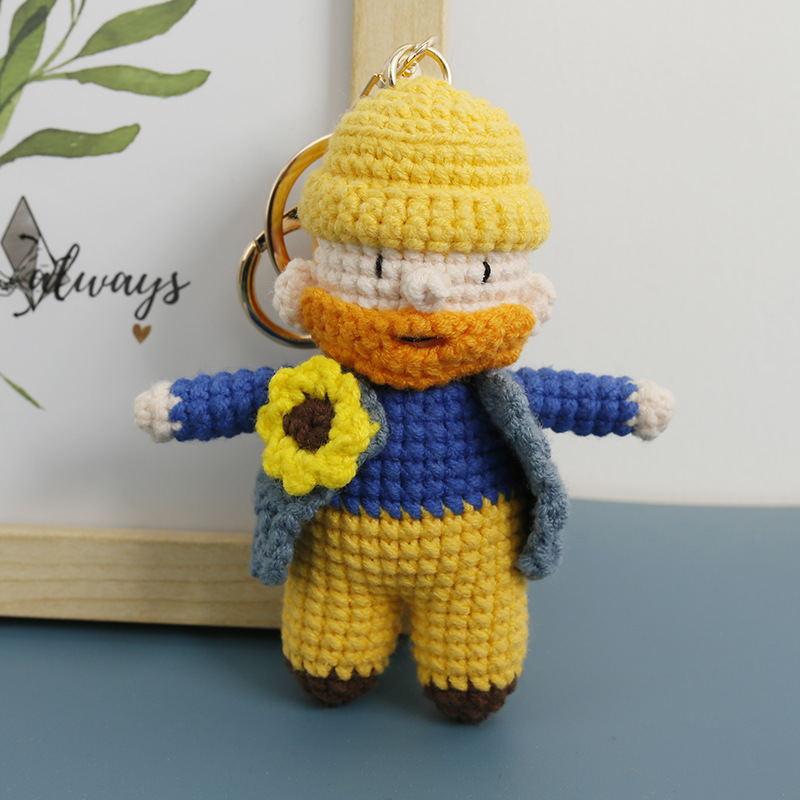 Yellow and blue crochet painter keychain with a sunflower detail