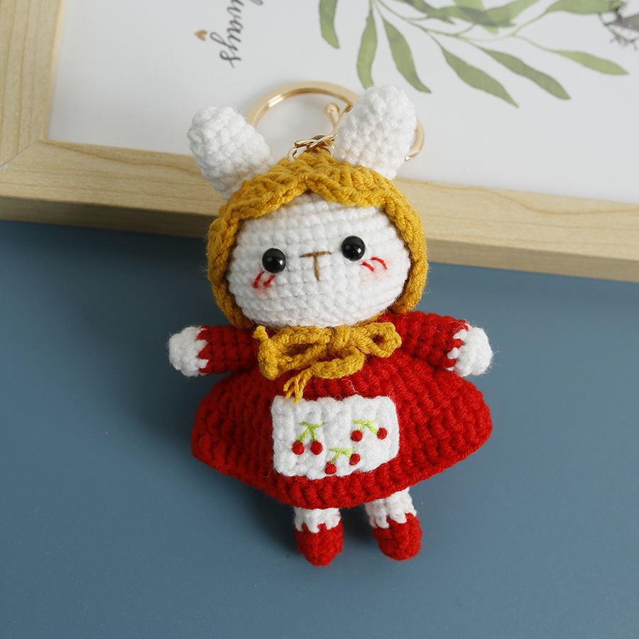 White crochet bunny keychain in a red cherry dress and mustard hood