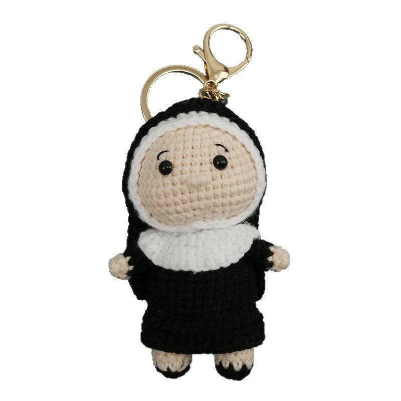 Black and cream crochet doll keychain with gold clasp