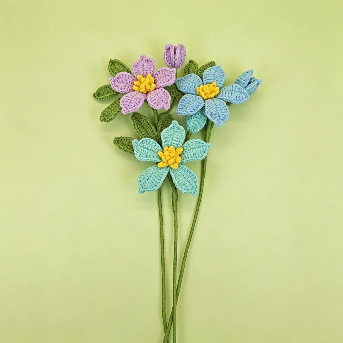 Blue and lavender clematis crochet flower stems on clean pastel backgrounds